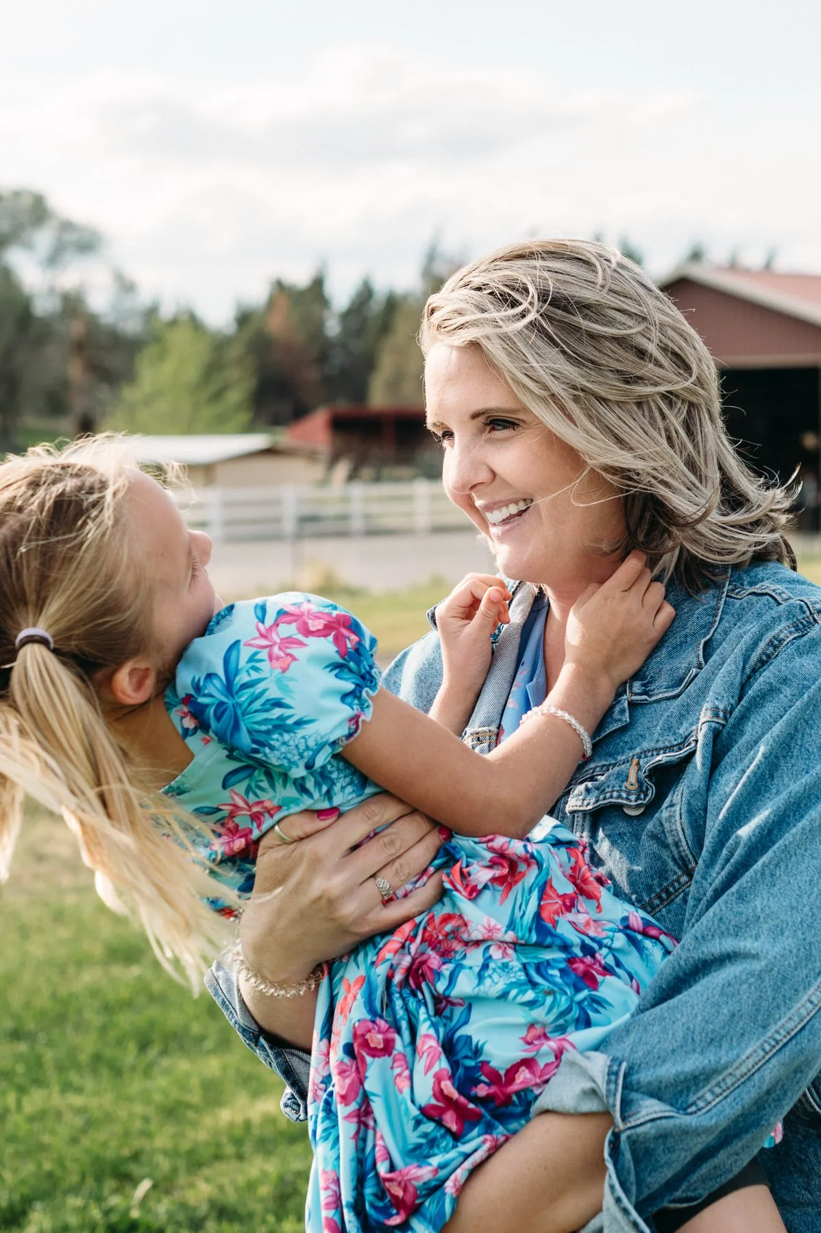 Mother holding daughter, both laughing joyfully by Elise Souders, Bend Family Photographer