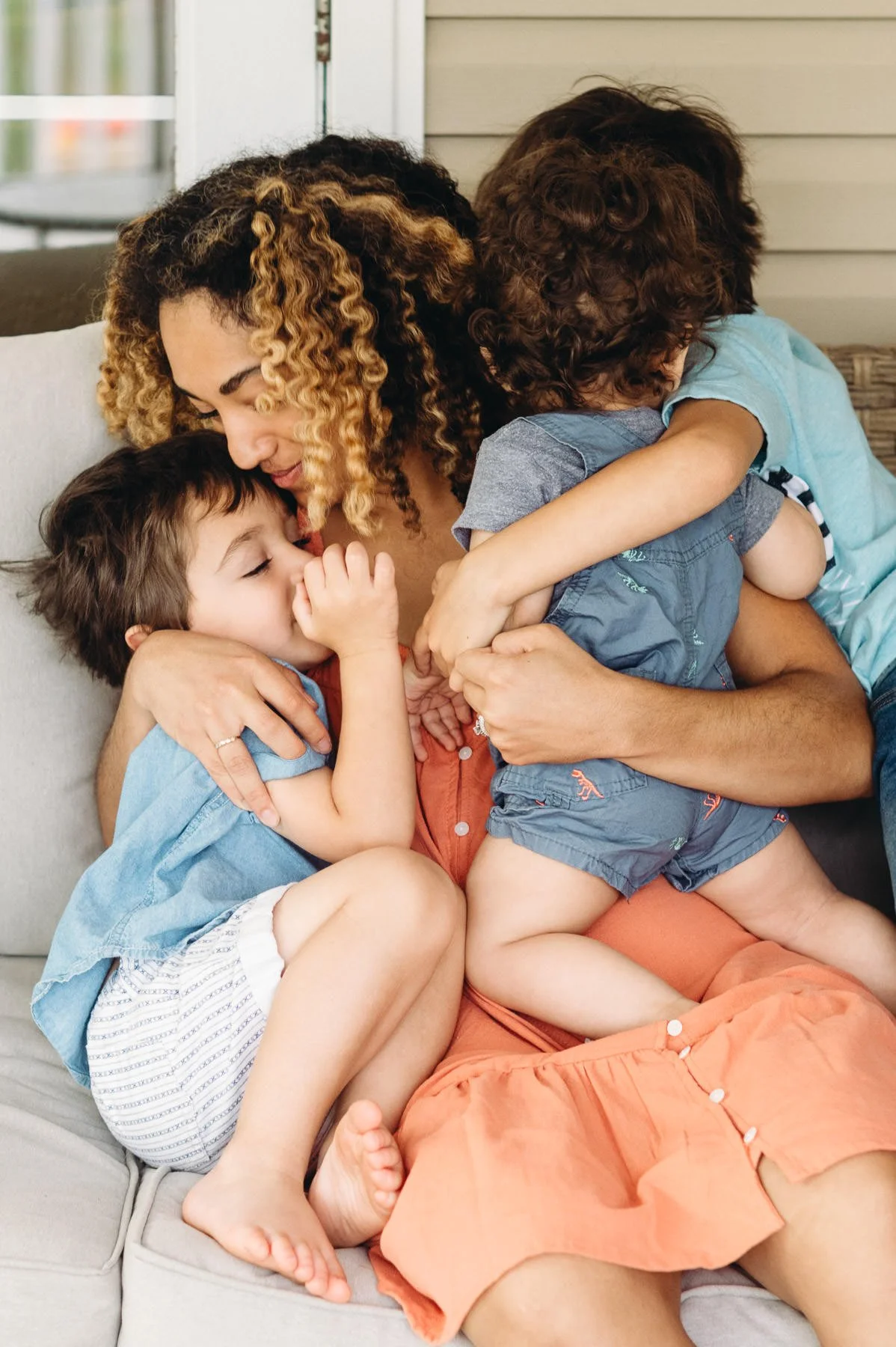 Candid moment of mother and sons cuddling on a couch together, Bend Family Photography by Elise Souders