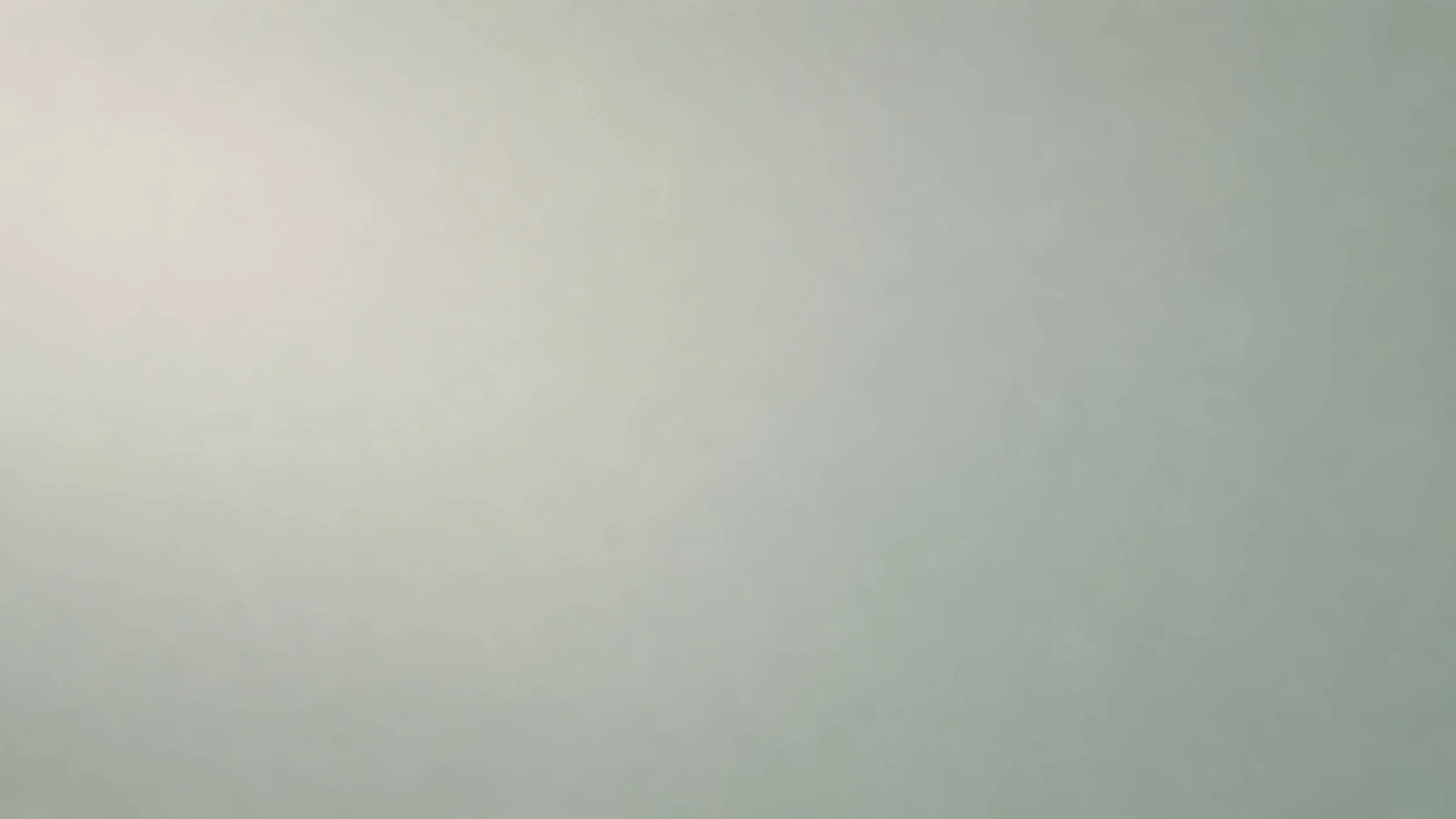 A blank, light-colored wall with a smooth texture.
