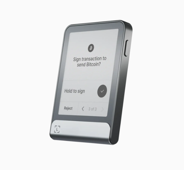 Smartphone screen displaying a Bitcoin transaction prompt with options to hold to sign or reject.