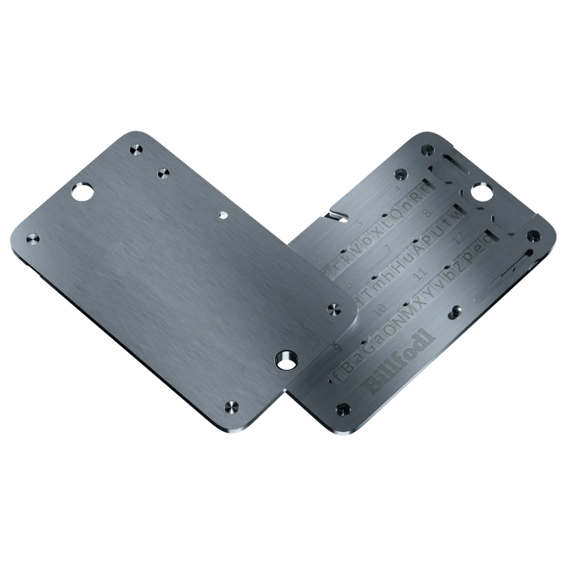 A metal template with slots, holes, and engraved measurement marks for aligning and assembling electronic components.