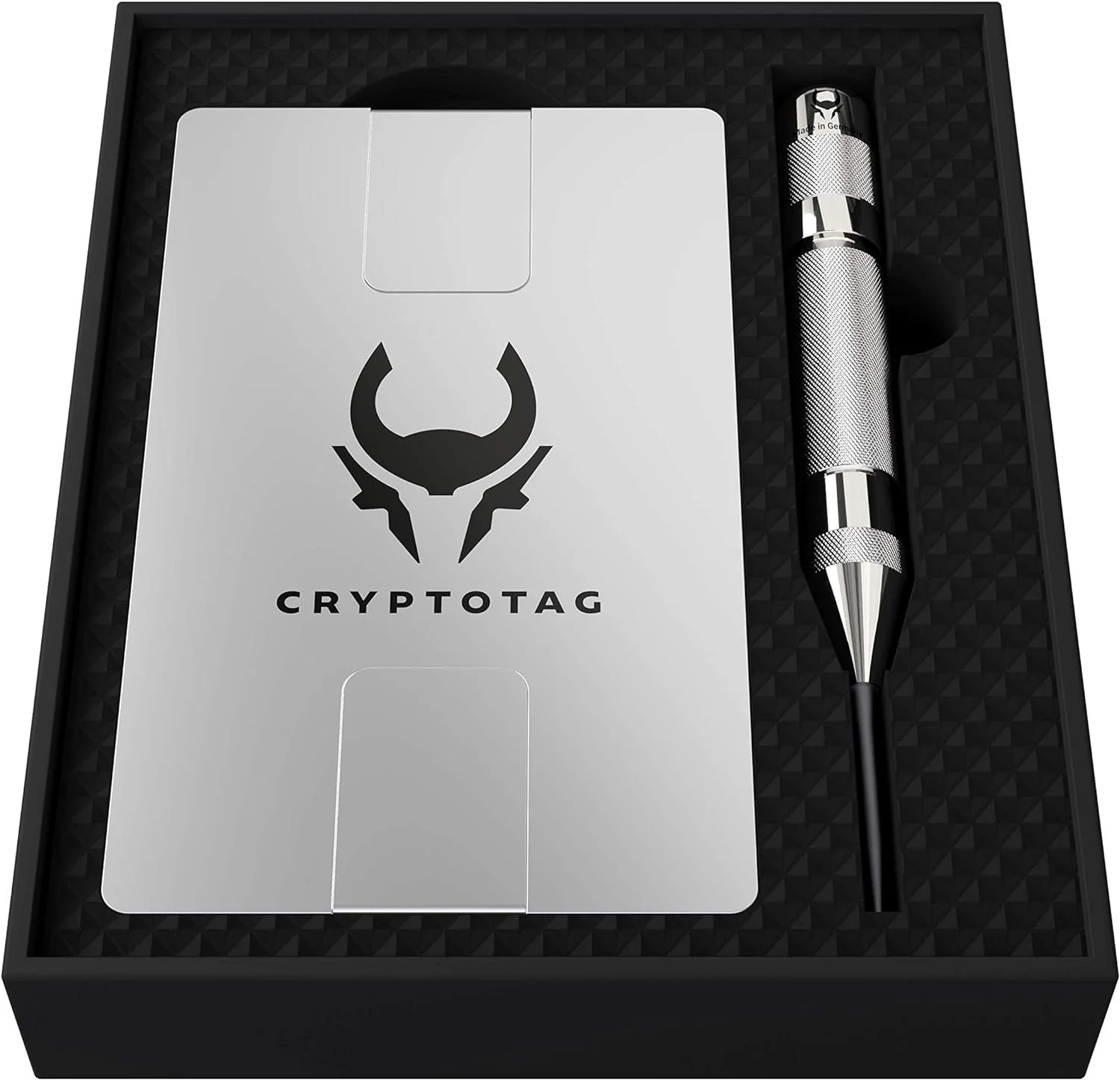 A Cryptotag-branded metal storage device, a silver and black metal pen, all in a black foam-lined box.