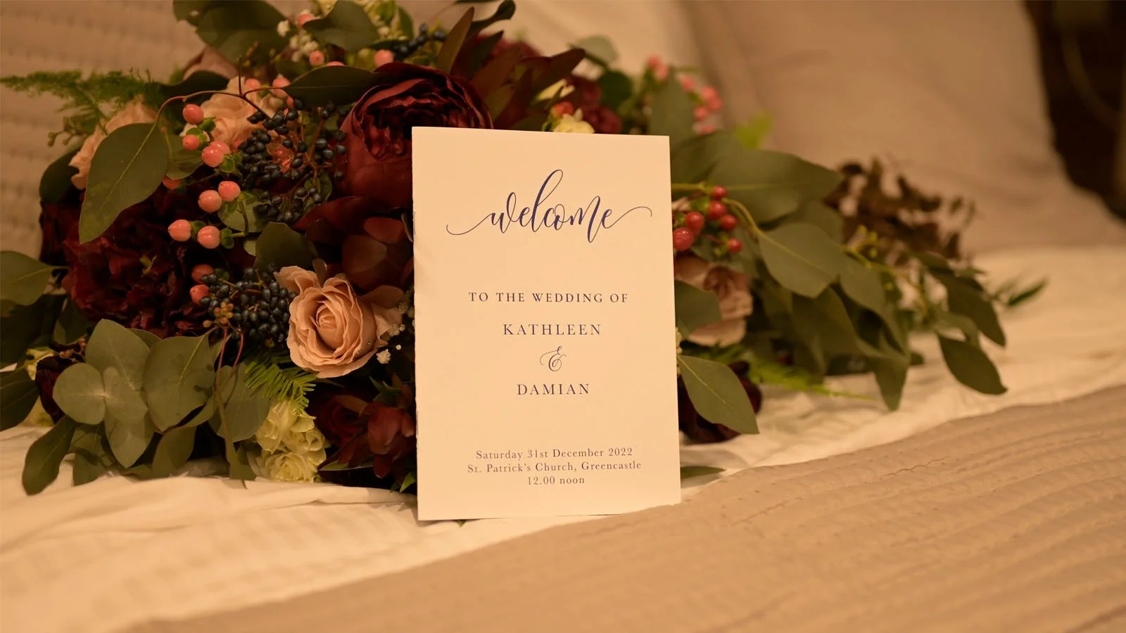 Wedding booklet printing in Cookstown which was ready for the ceremony.  The booklets are sitting in the hotel room with bouquets behind them.