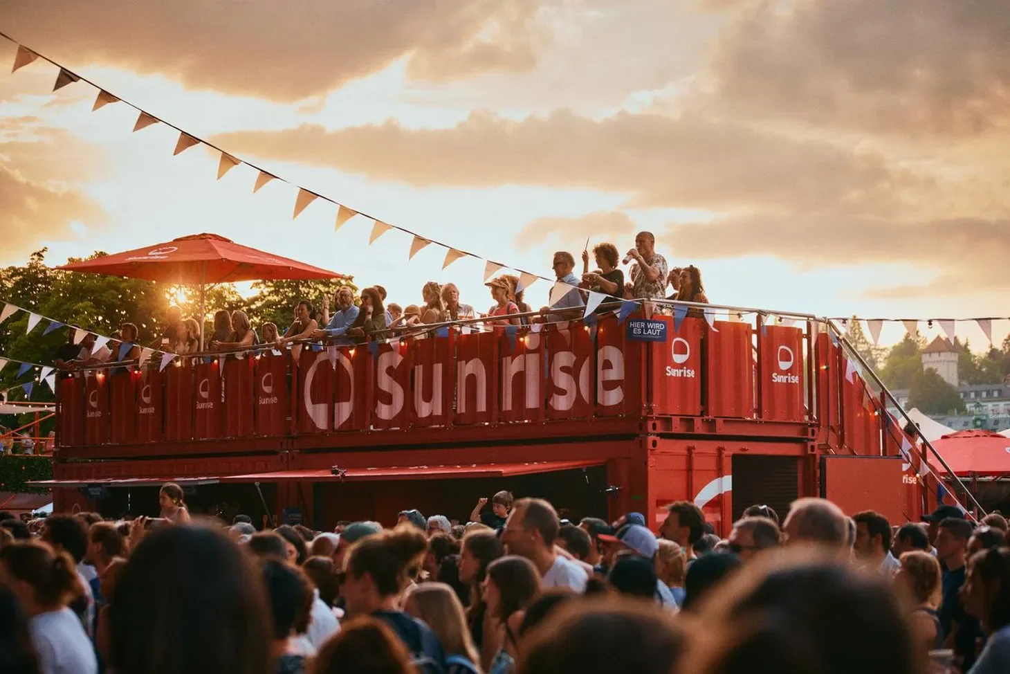 Festival crowd at the Sunrise container stage at sunset