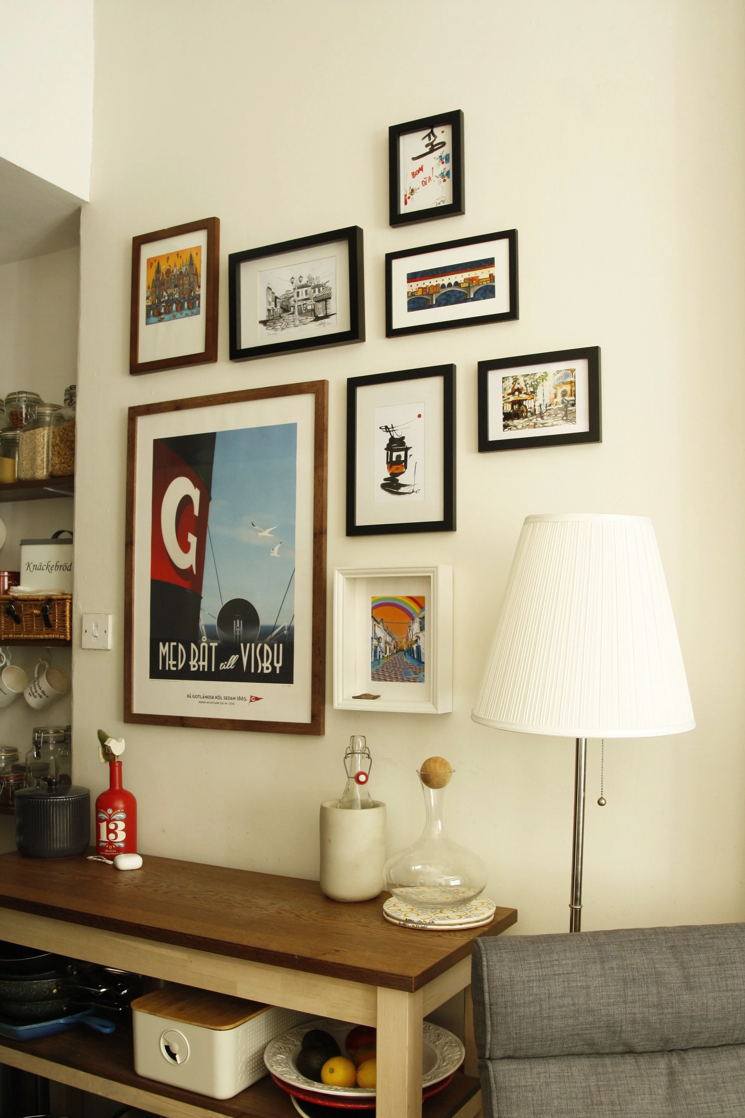 Montage wall of holiday pictures, designed and hung in Canonmills, Edinburgh. Kitchen picture gallery wall design. 