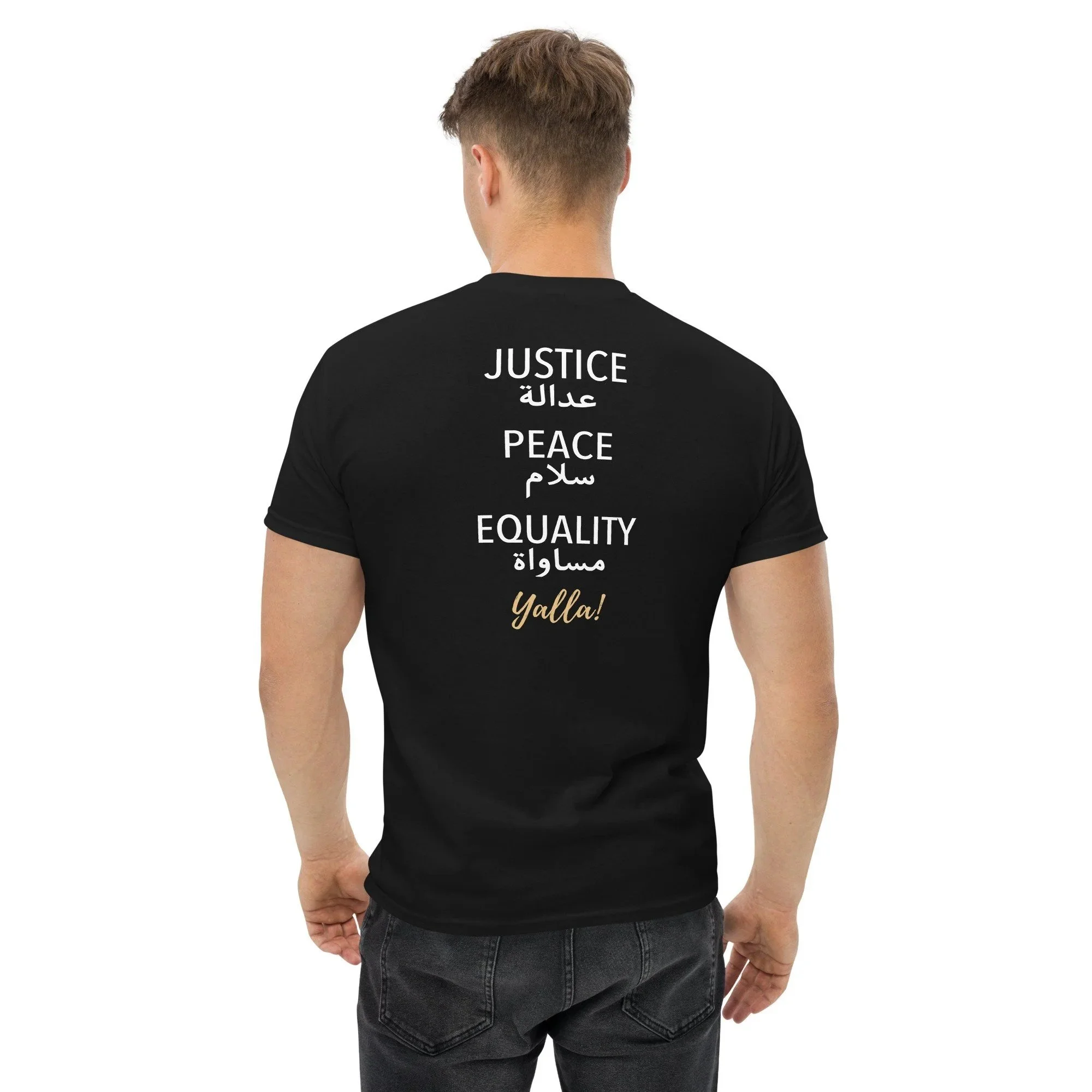 Back view of a man wearing a black t-shirt with words in English and Arabic promoting justice, peace, and equality, including "Yalla!" in gold script.