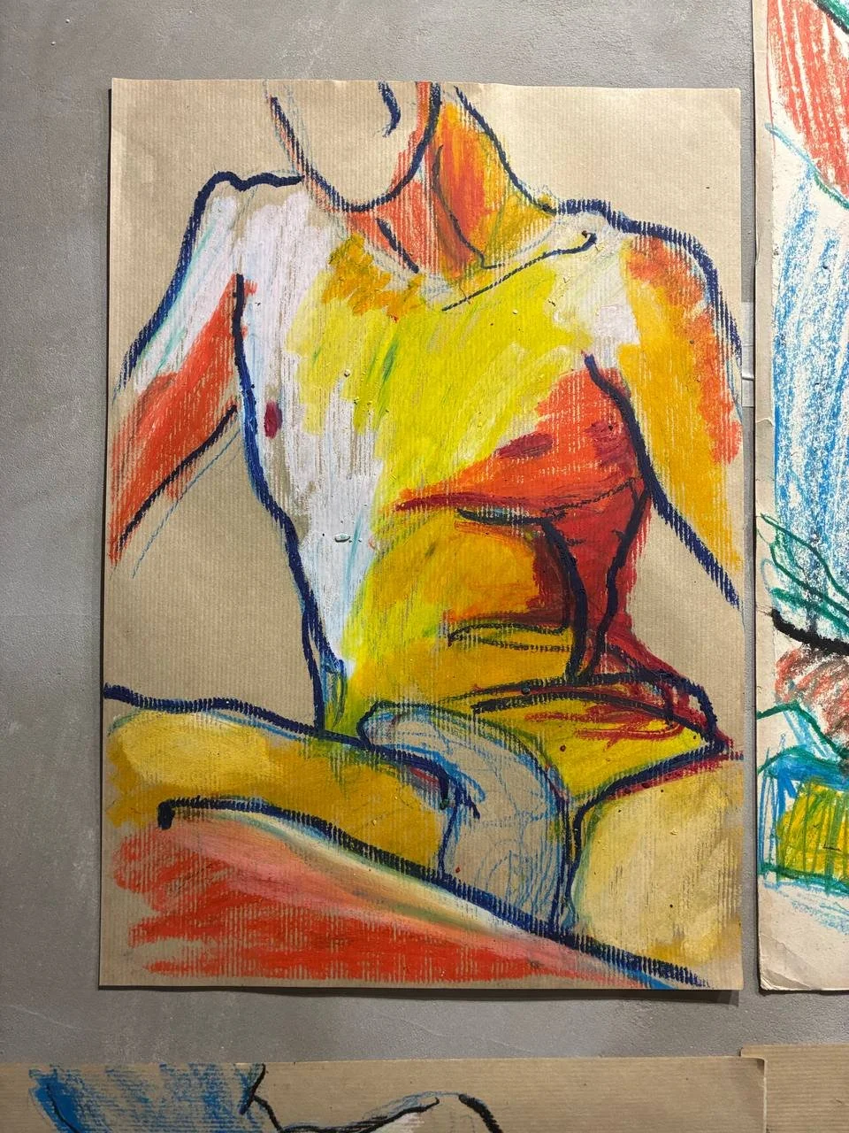 Colorful abstract drawing of a seated person, using vibrant colors like yellow, red, orange, and blue.