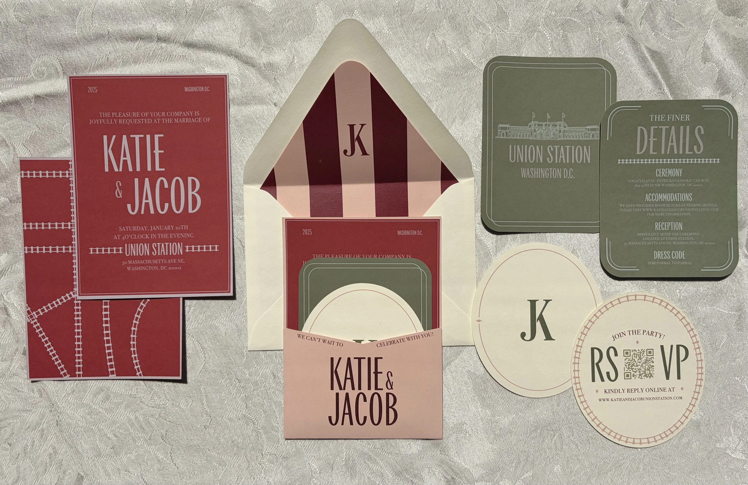 Wedding invitations and RSVP cards for Katie and Jacob, including an envelope, a red card with event details, a green card with venue information, and decorative items, all laid out on a table.
