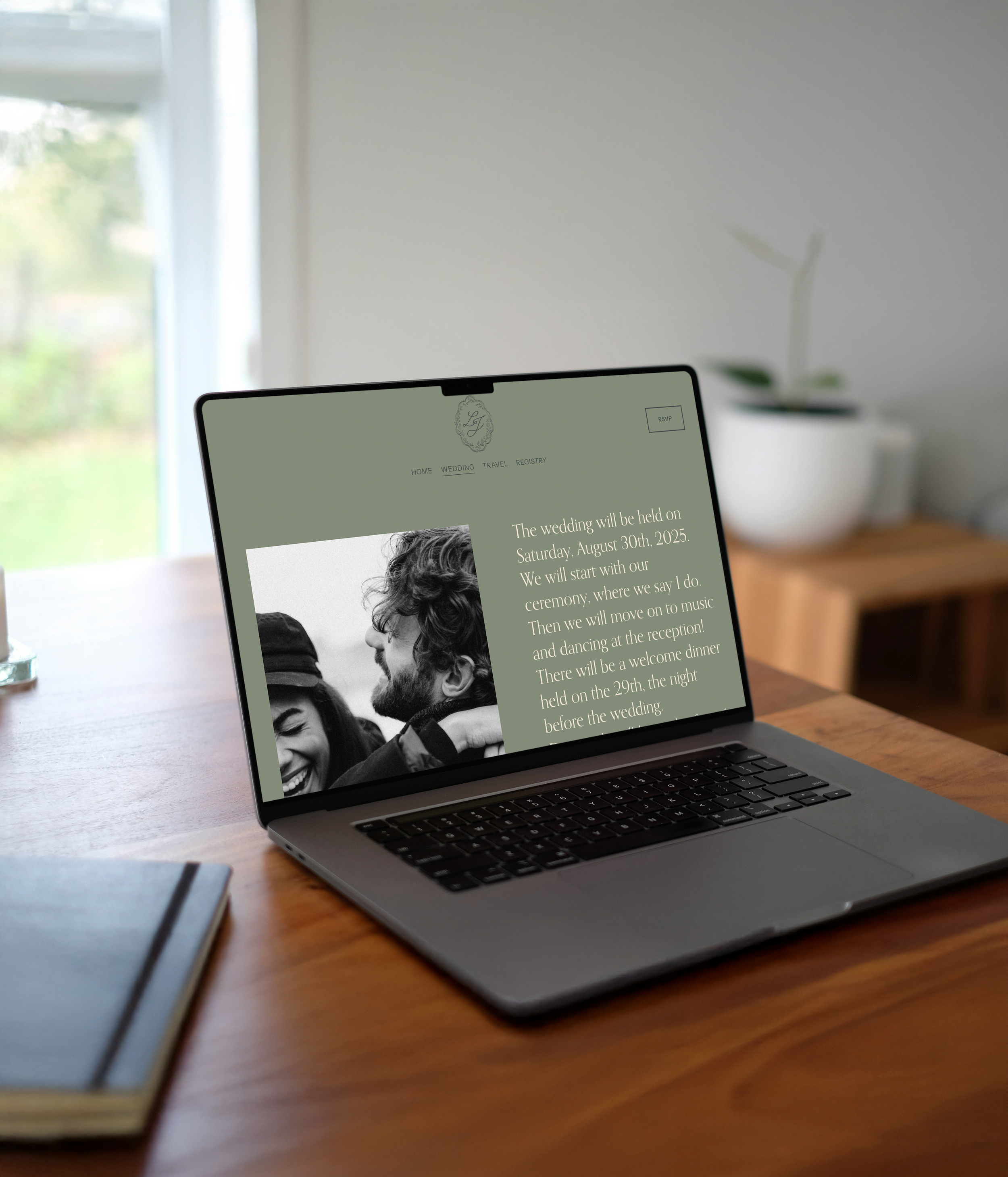 Laptop on wooden table displaying a wedding website with photo of couple and details about the wedding date and schedule.