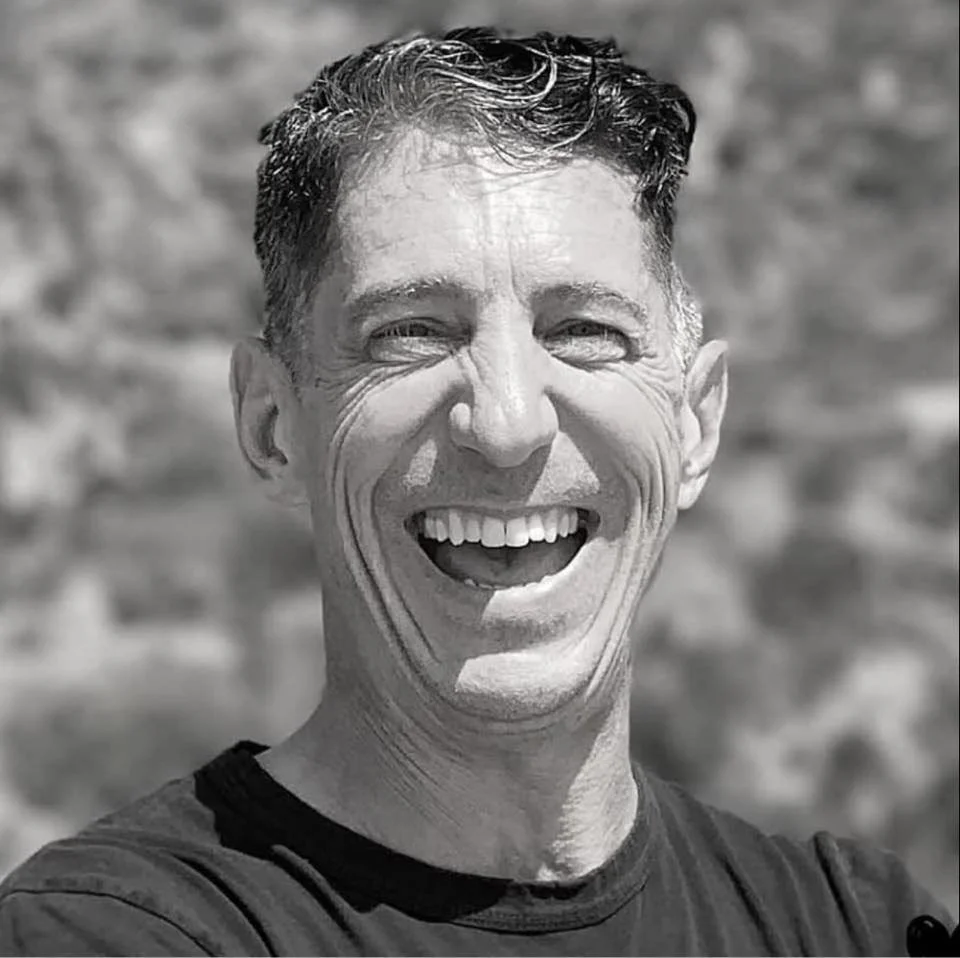 a picture of Andry Petranek laughing in black and white