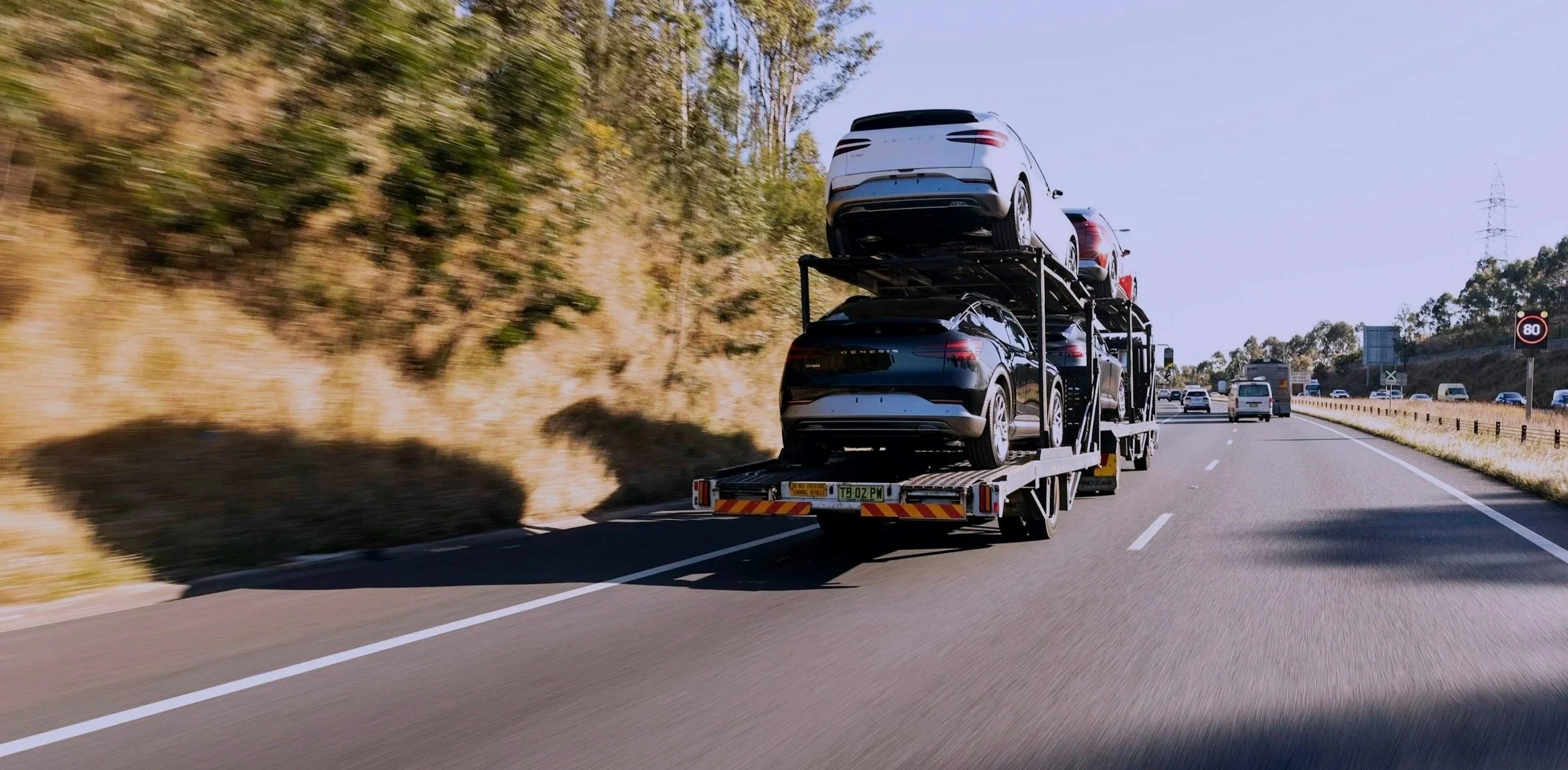 Truck transporting several cars on an auto transport trailer