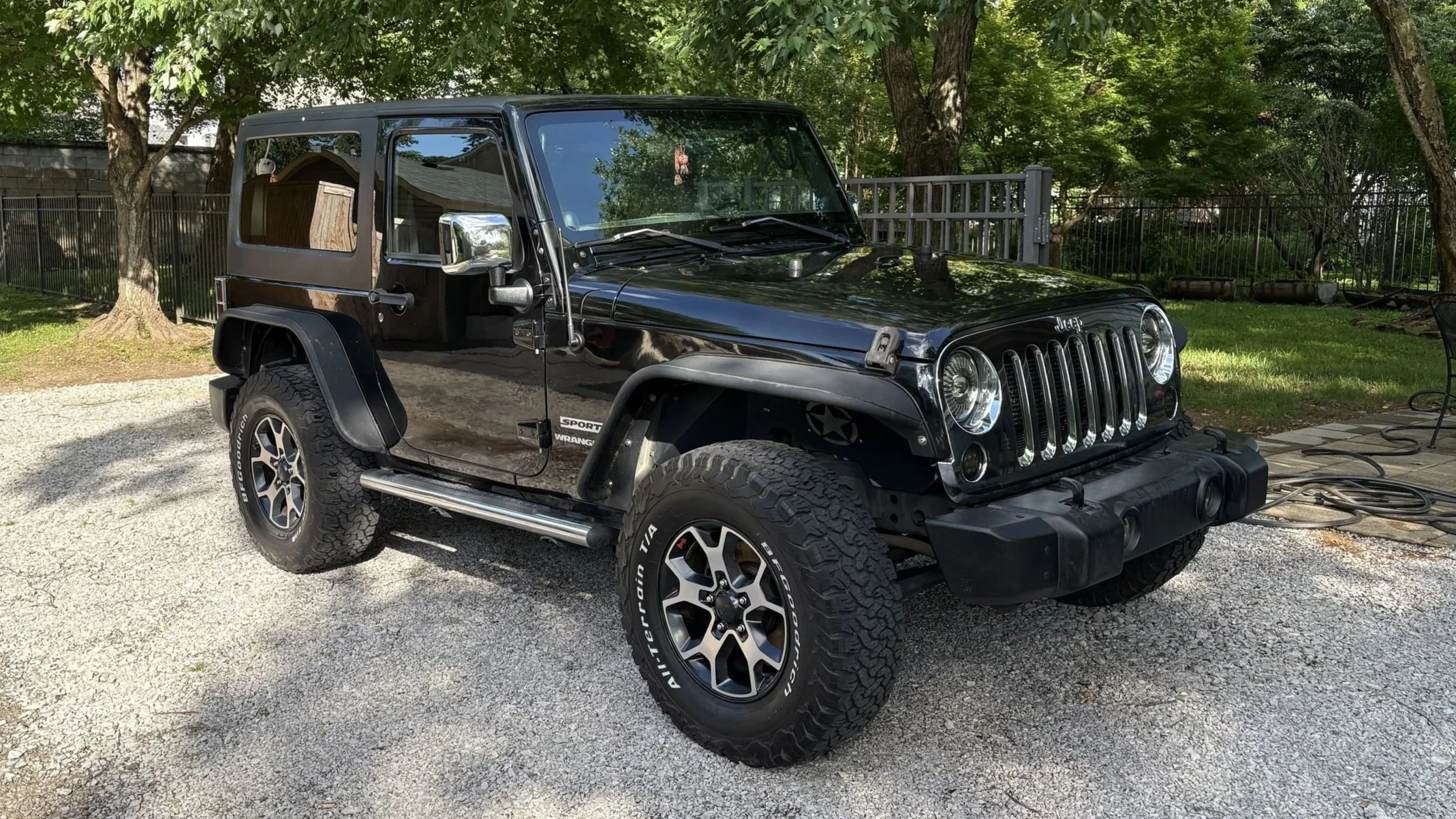 Clean Black Jeep Wrangler parked on gravel driveway after an exterior mobile detail in Hopkinsville, KY.