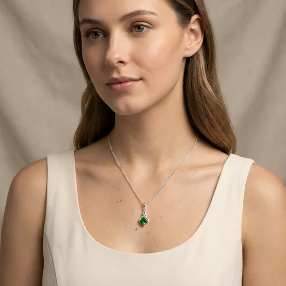 Sterling Silver Celtic Knotwork Pendant, square-cut green CZ stone, bezel set, shown on model at neckline giving scale