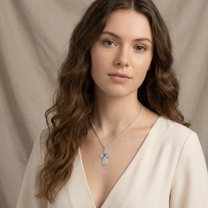 Sterling Silver Celtic cross pendant with amethyst, shown on model at neckline giving scale