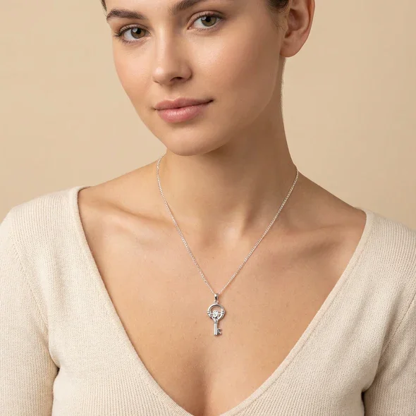 Sterling Silver Claddagh Key Pendant, hands heart and crown motif, high mirror polish, shown on model at neckline giving scale
