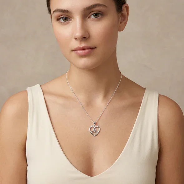 Sterling Silver Celtic Heart Trinity Knot Pendant, open heart frame, triquetra detail, shown on model at neckline giving scale