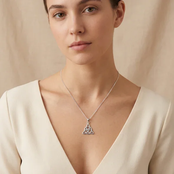 Sterling Silver Celtic Trinity Knot Pendant, triquetra design, high mirror polish, shown on model at neckline giving scale