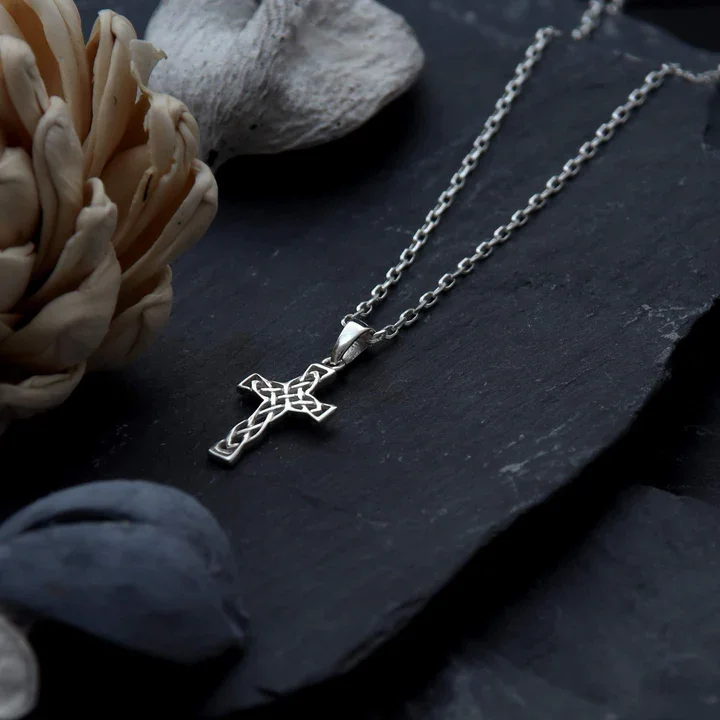 Sterling Silver Celtic cross pendant, shown on Scottish slate with sea stones and dried botanicals