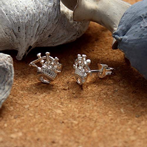 Sterling Silver Scottish Bagpipes Stud Earrings, sculpted Highland pipes form, crosshatched bag detail, 9mm x 9mm, push back fitting, shown on cork with sea stones and dried botanicals