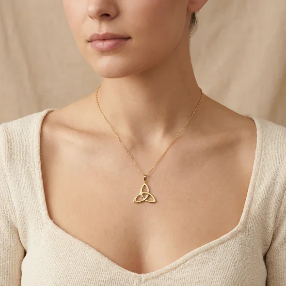 Gold Plated Sterling Silver Celtic Trinity Knot Pendant, triquetra design, mirror polish, shown on model at neckline giving scale