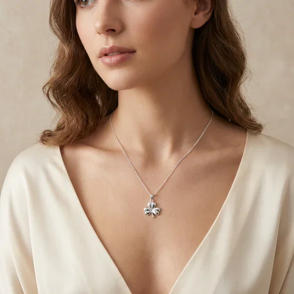 Sterling Silver Irish Shamrock Pendant, sculpted three-lobe form, high mirror polish, shown on model at neckline giving scale