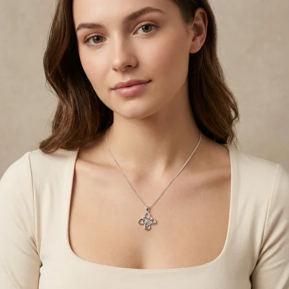 Sterling Silver Celtic Knotwork Heart Pendant, four-loop interlaced design, open heart detail, shown on model at neckline giving scale