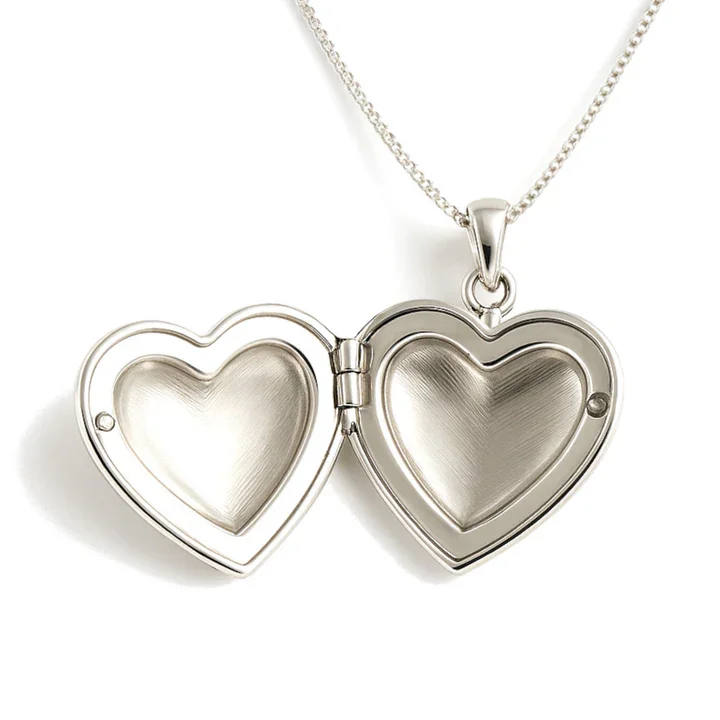 Sterling Silver heart locket, mid-size. Plain high mirror polish, displayed open showing internal photo clasp