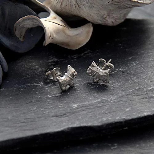 Sterling Silver Scottish Terrier Stud Earrings, sculpted Scottie dog form, engraved coat detail, 8mm x 7mm, push back fitting, shown on Scottish slate with sea stones and dried botanicals