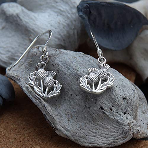 Sterling Silver Scottish Thistle Drop Earrings, oxidised finish, feathered head, open leaf design, 12mm x 10mm, fish hook fitting, shown on cork with sea stones and dried botanicals.