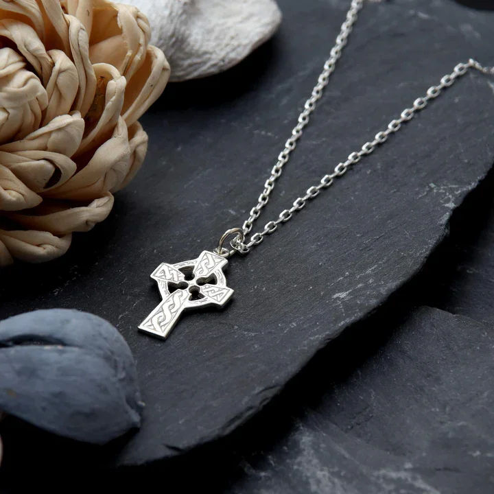 Sterling Silver Celtic cross pendant, shown on Scottish slate with sea stones and dried botanicals
