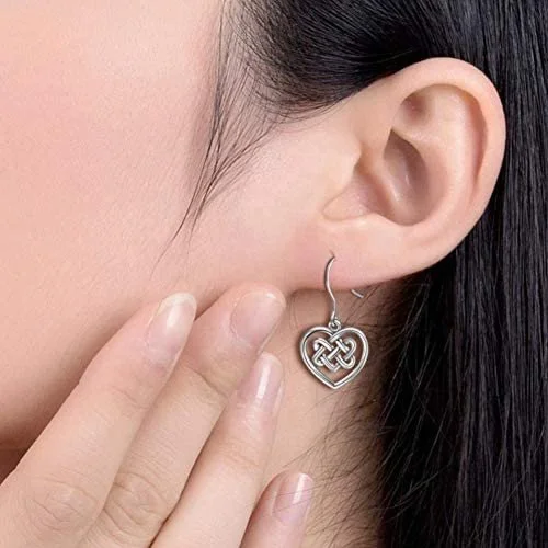 Sterling Silver Celtic Knotwork Heart Drop Earrings, basketweave interlace interior, open heart frame, fish hook fitting, shown on model at ear.
