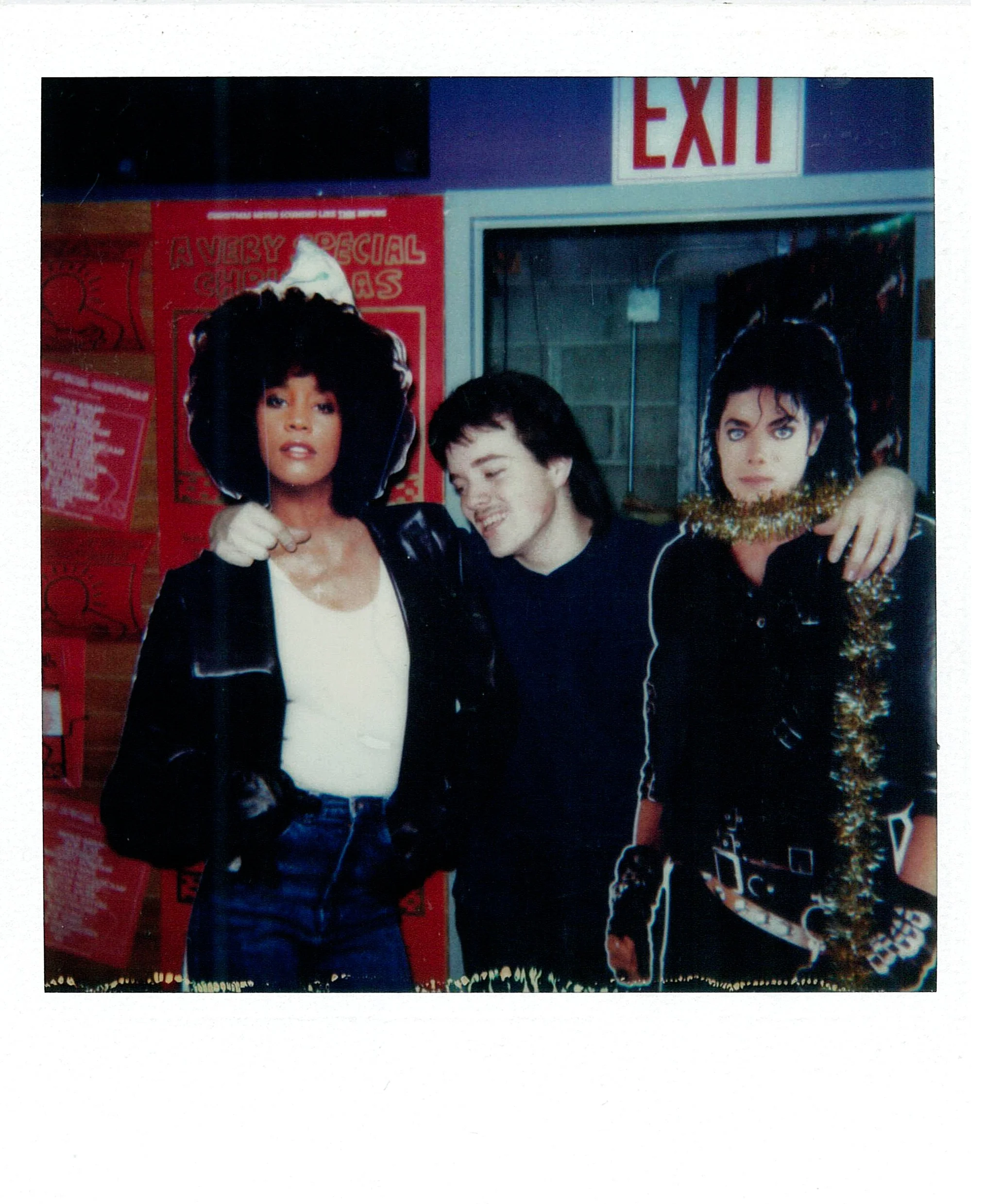 Joe O'Donnell as a teenager posing between cardboard cutouts of Whitney Houston and Michael Jackson, reflecting the pop music influences explored in his memoir.