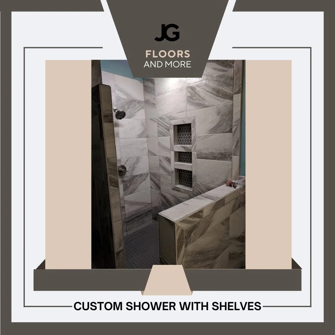 Interior of a custom shower with marble tiles, built-in shelves with honeycomb pattern, and a partial bench, featuring a modern design.