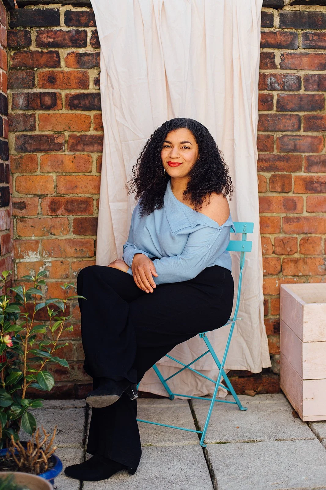 Lorelle sitting on a chair outdoors