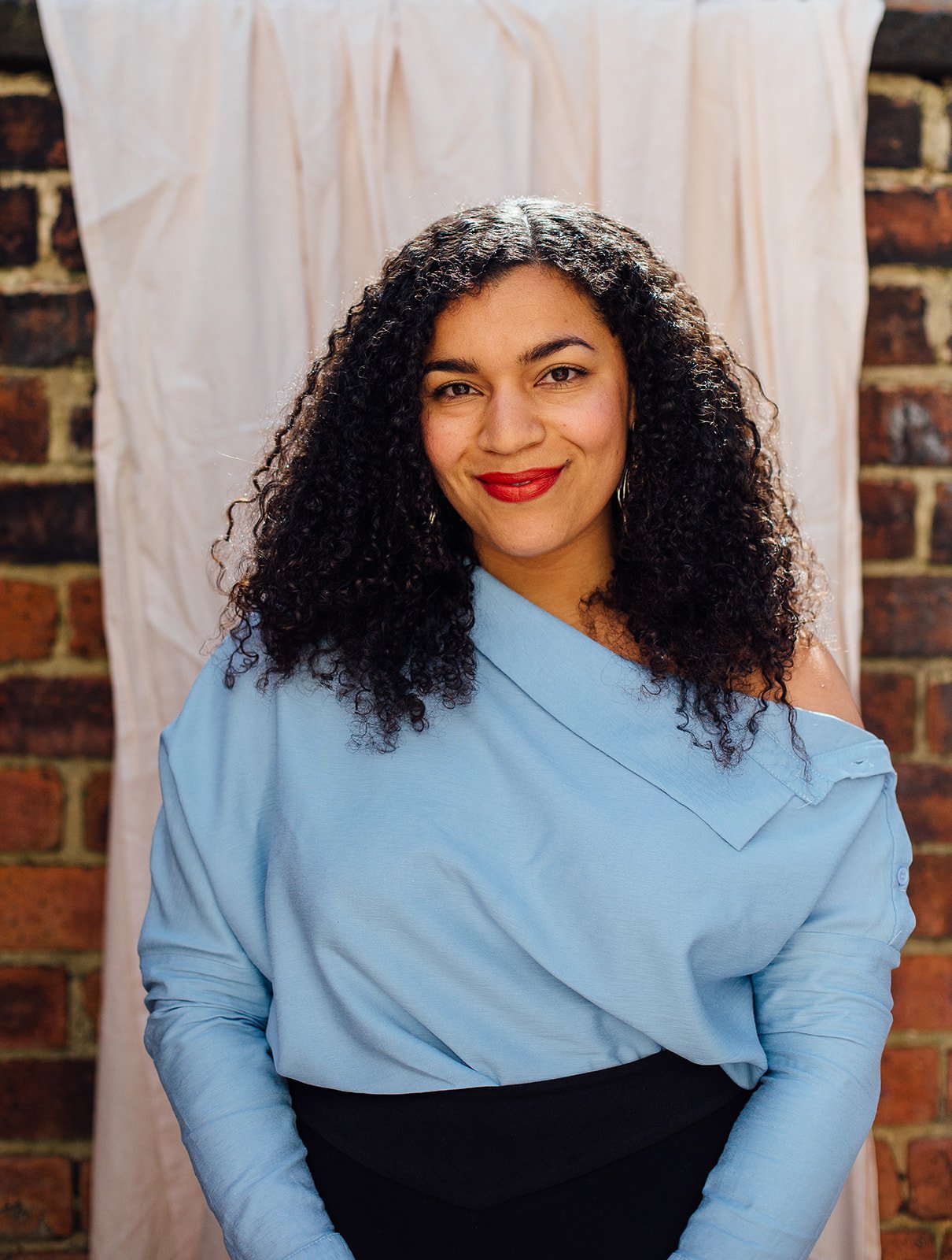 Lorelle wearing a blue shirt, smiling at the camera