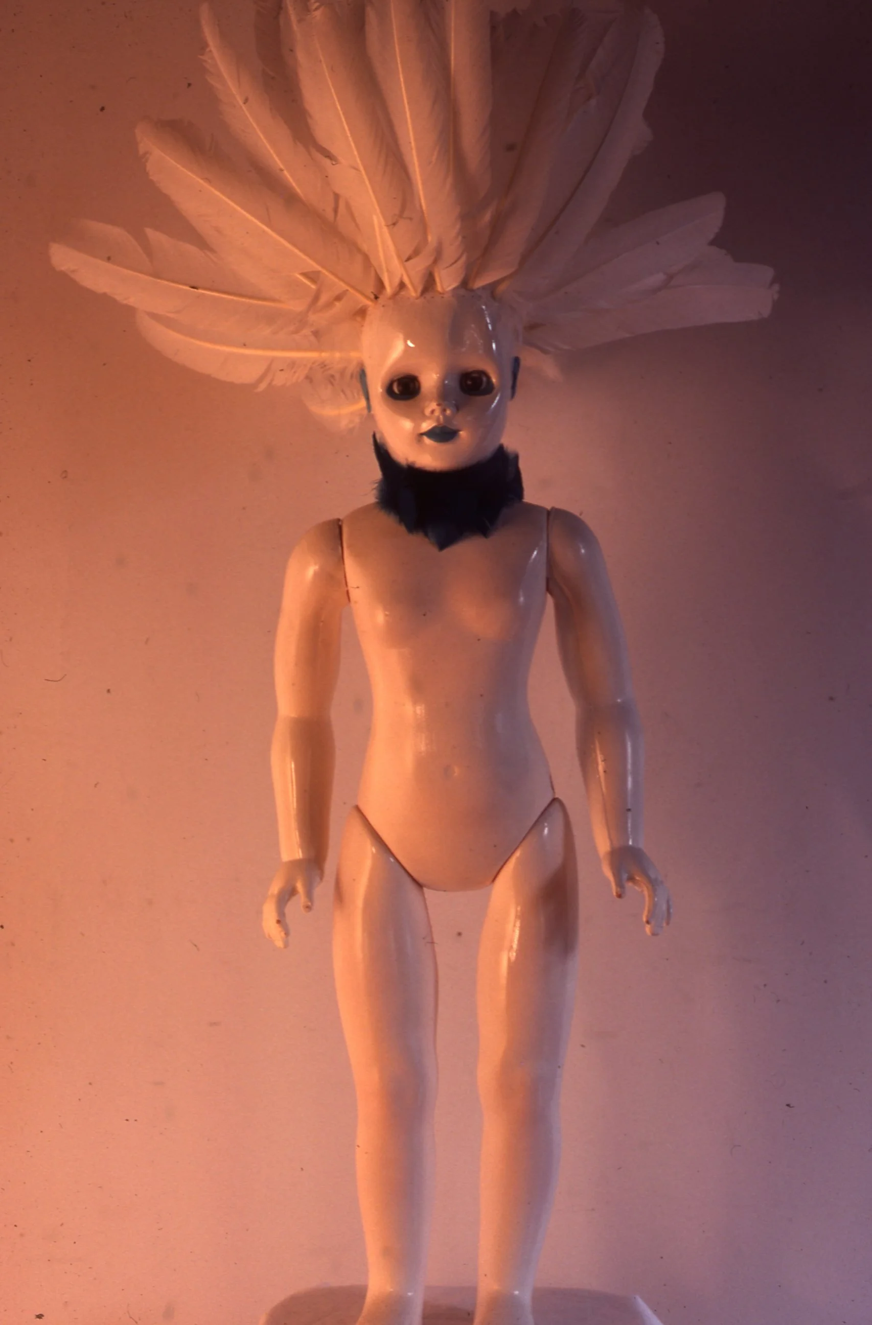 Enamel on Plastic Doll and Feathers 1979