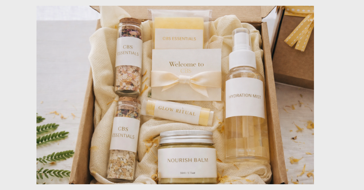 Self-care gift box with CBD essentials, glow ritual, nourish balm, hydration mist, greeting card with bow, and yellow ribbon.