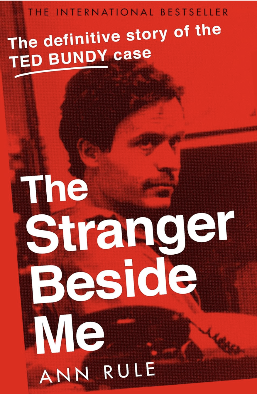 Book cover titled "The Stranger Beside Me" by Ann Rule, featuring a red-tinted photo of Ted Bundy with text highlighting it as a story of the Ted Bundy case and an international bestseller.