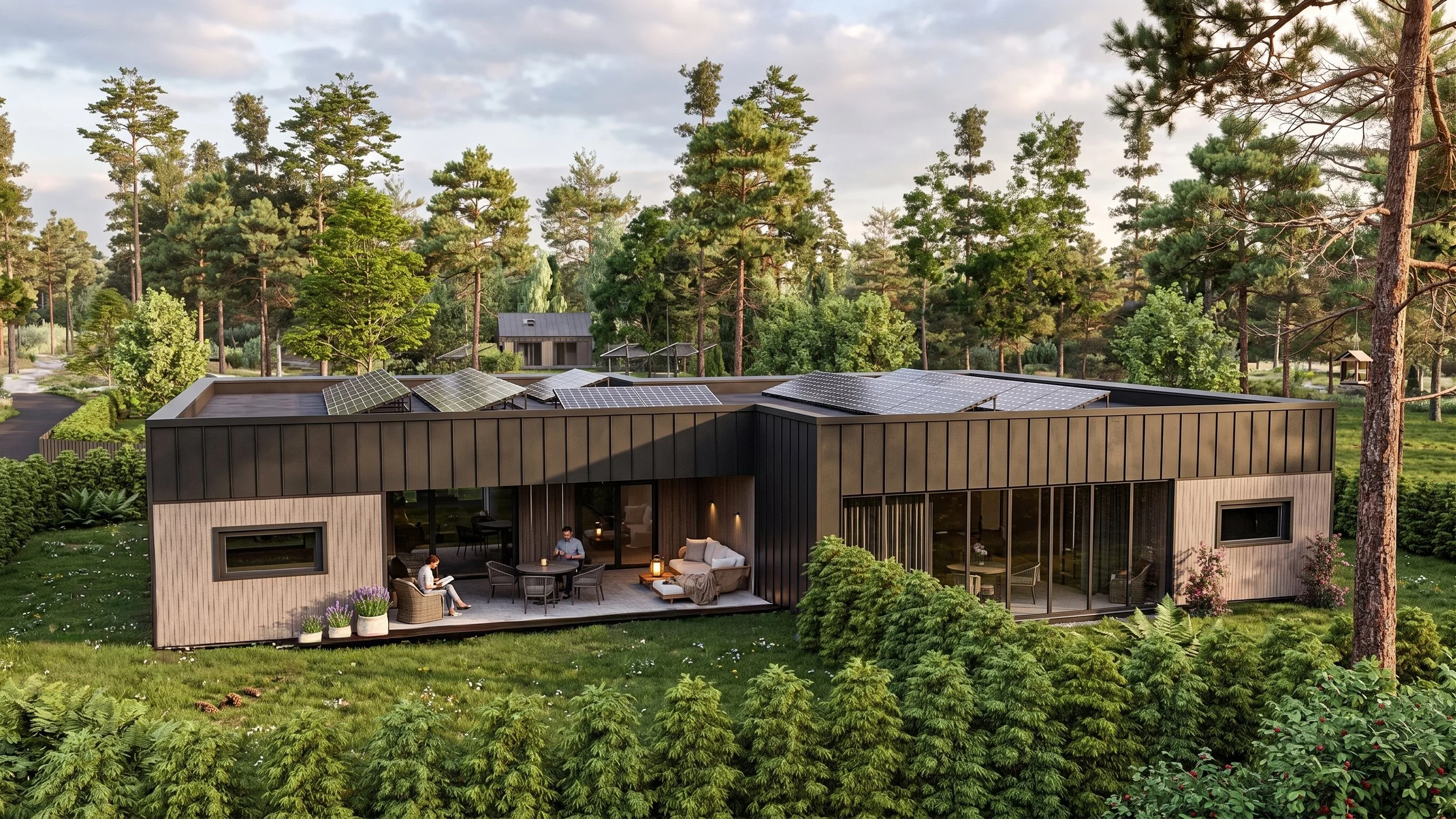 Modern house with solar panels on the roof, surrounded by tall trees and greenery, and an outdoor seating area with two people sitting and talking.