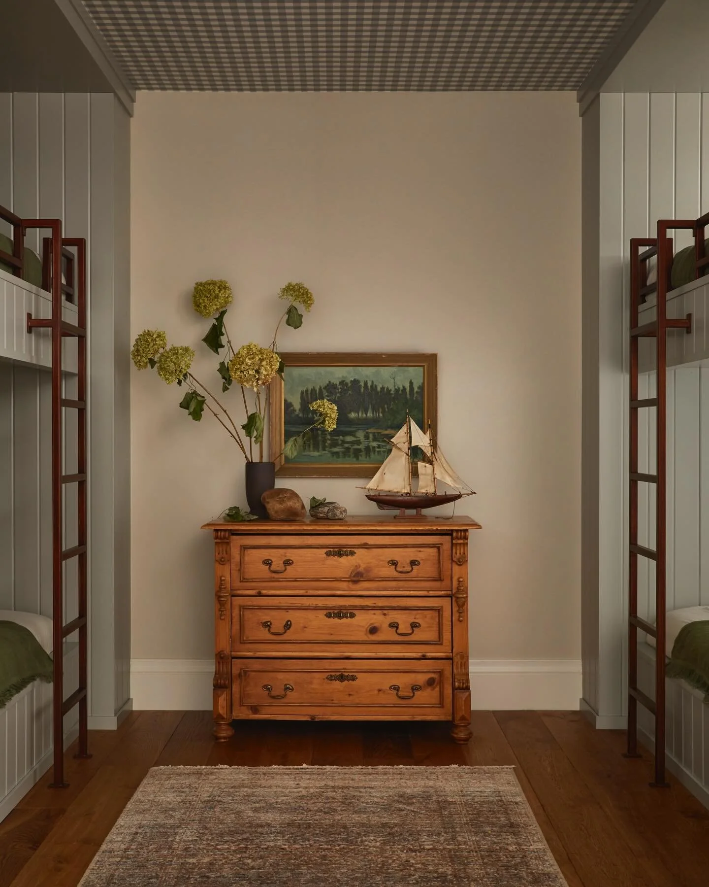 Soft symmetry, layered nostalgia, and a quiet sense of place. 
A tucked-away moment where vintage wood, gingham overhead, and collected details tell a calm, cottage-rooted story. Thoughtful, unfussy, and made to feel lived in. 
&bull;
&bull;
&bull;
#