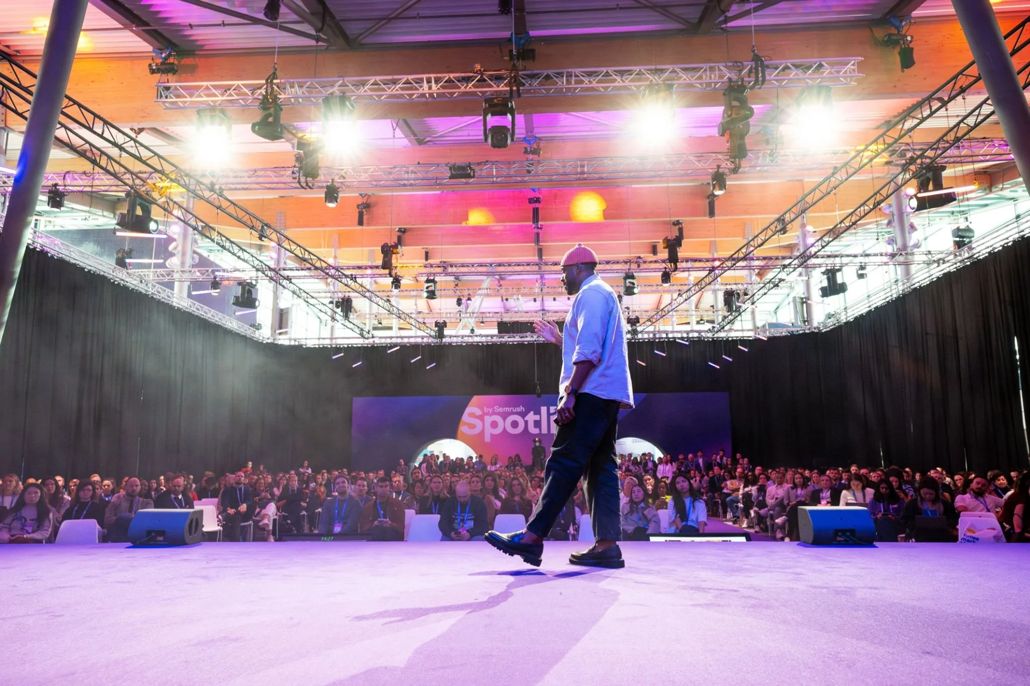 Brandon Smithwrick walking on stage in front of a large audience at a conference or event.