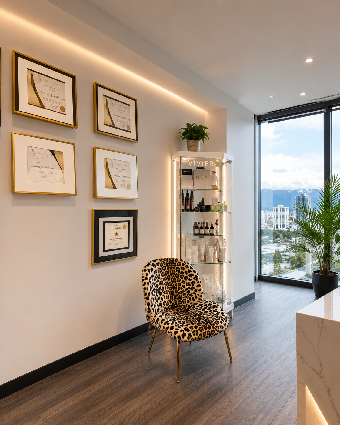 A modern interior space with a wall of framed certificates, a leopard print chair, a glass display cabinet with skincare products, a large window overlooking city and mountains, a potted plant, and a marble counter.