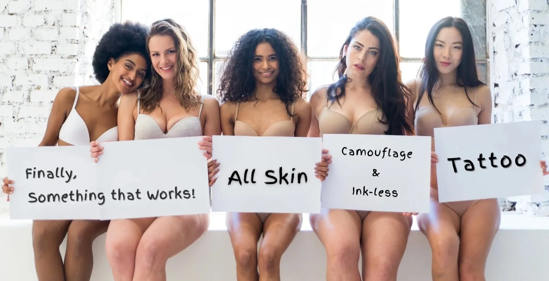 Five diverse women in underwear holding signs promoting skin-friendly tattoos, smiling and sitting on a windowsill in a bright, industrial-style room.