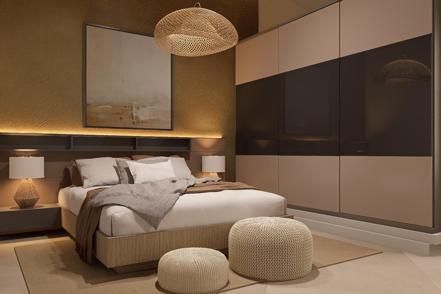 A modern bedroom with a large bed, gray bedding, two matching nightstands with lamps, a beige textured accent wall, a large framed abstract painting, a beige rug, and a sleek, glossy wardrobe with beige and black panels.