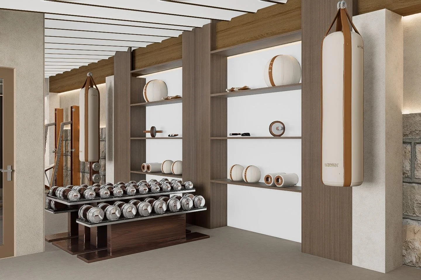 Gym area with dumbbells on racks, and foam rollers and wall-mounted equipment storage, in a modern fitness room.