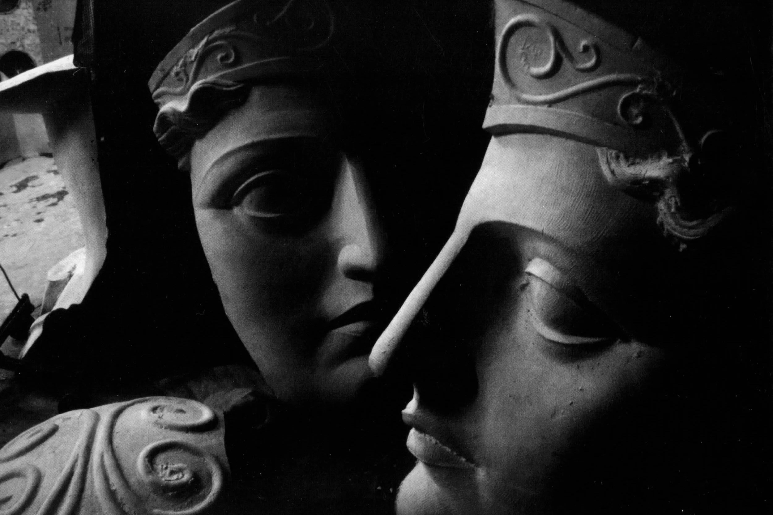Close-up of a decorative sculpture or mask with intricate carvings, showing part of a face and ornate details in black and white. Athena Parthenos in Parthenon Museum Nashville. 