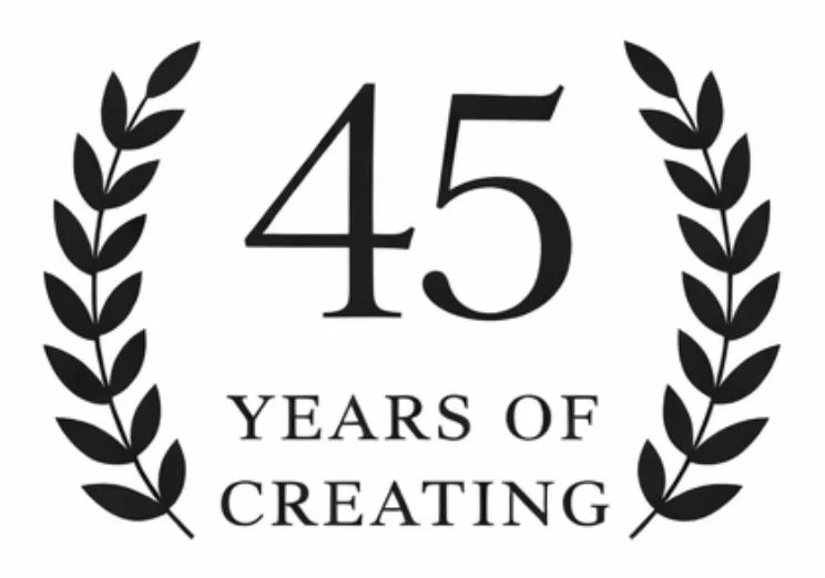 Celebrating 45 years of creating, with laurel branches on each side.