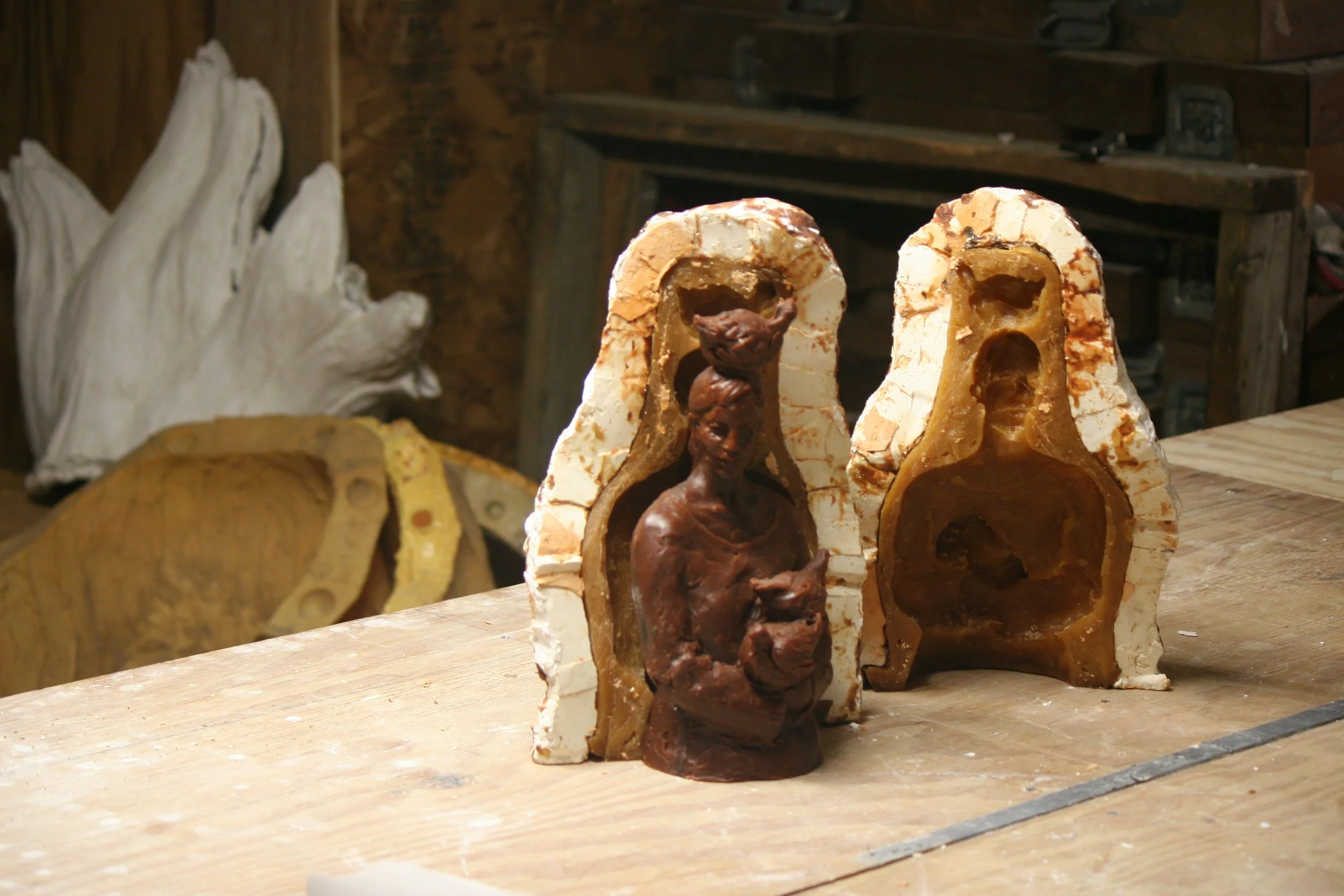 A rubber mold, mother mold, and wax casting of woman with chickens. Sculpture. Mold making
