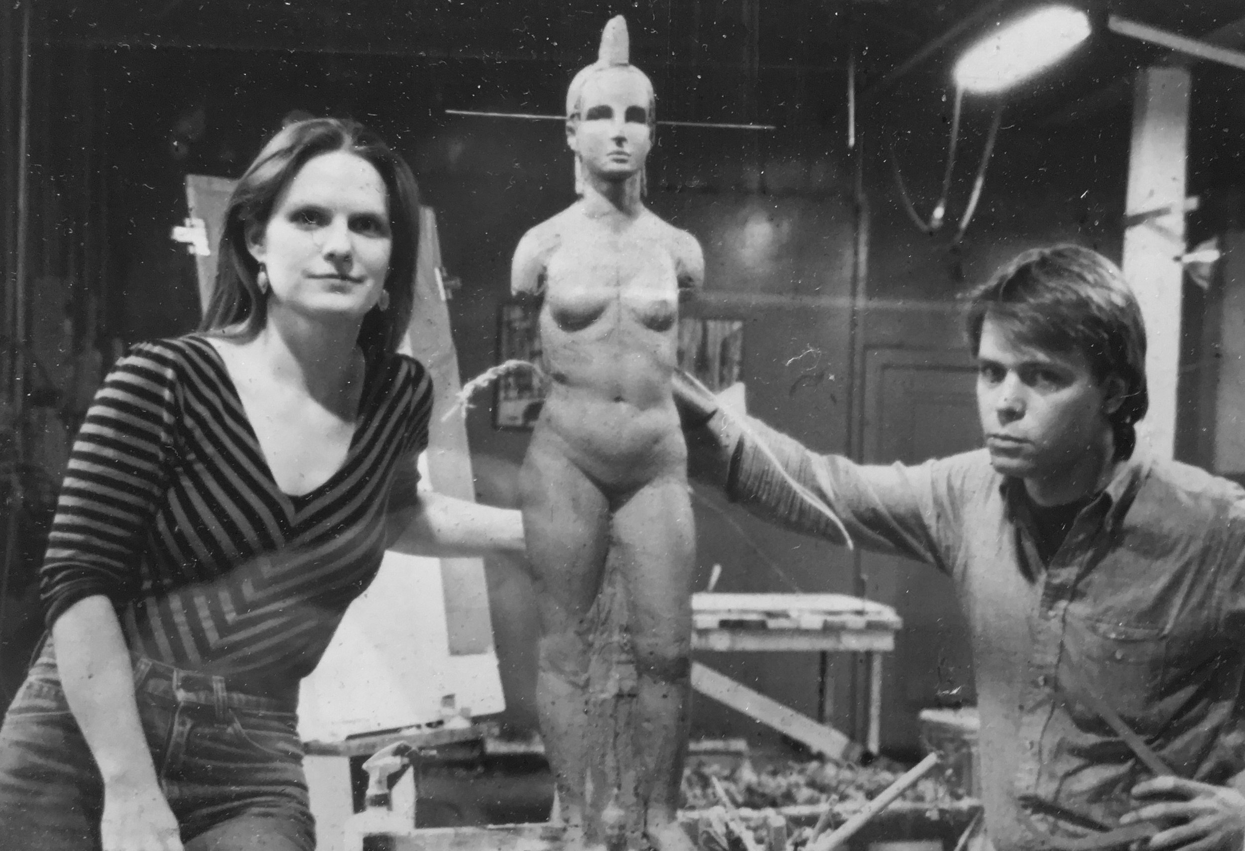 Black and white photo of a woman and a man posing with a model in a workshop. Athena Parthenos in Parthenon Museum Nashville. 