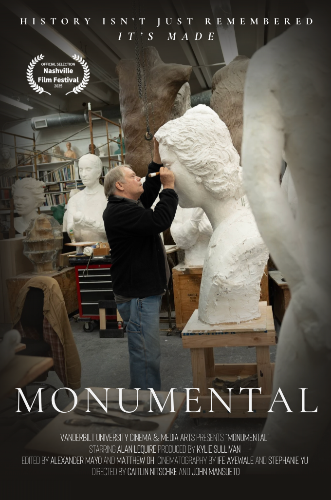 An artist working on a large marble bust in a sculpture studio filled with other busts and sculptures, with shelves of books in the background.